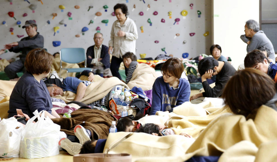 Evacuees rest at a gym-turned shelter in Murakami, Niigata prefecture, northwestern Japan, early Wednesday, June 19, 2019, after an earthquake. The powerful earthquake jolted northwestern Japan late Tuesday, prompting officials to issue a tsunami warning along the coast which was lifted about 2 ½ hours later. More than 1,500 people took shelter at evacuation centers in Murakami city and elsewhere in Niigata. (Yusuke Ogata/Kyodo News via AP)