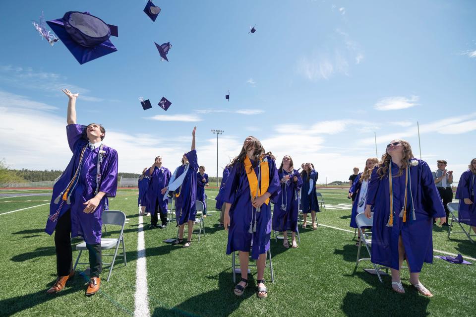Rye High School's Class of 2021 toss their caps at their 2021 graduation ceremony.