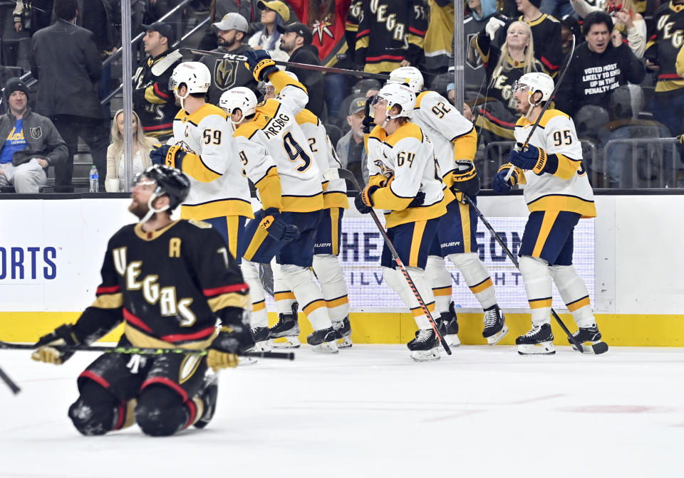 The Nashville Predators celebrate a goal against the Vegas Golden Knights during the third period of an NHL hockey game Saturday, Dec. 31, 2022, in Las Vegas. (AP Photo/David Becker)