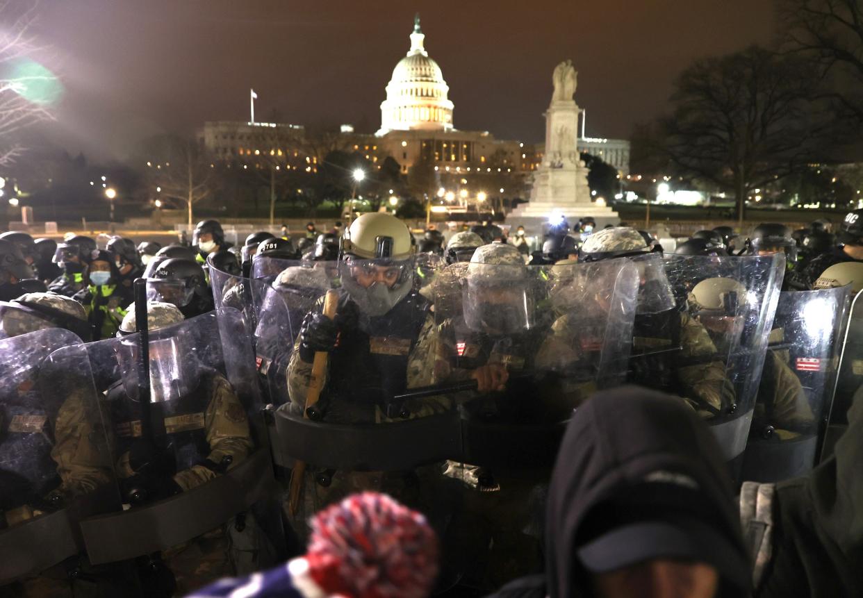 Members of the National Guard assist police officers in dispersing protesters who are gathering at the U.S. Capitol Building on January 6, 2021 in Washington, DC.