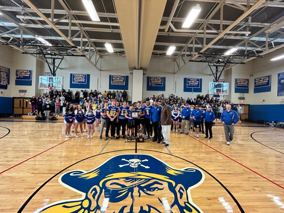 Hull High football coach Mike O'Donnell, second from right, poses with his team and New England Patriots Hall of Fame linebacker Andre Tippett at the school on Tuesday, Nov. 29, 2022. O'Donnell was named the New England Patriots High School Coach of the Week for the Pirates' 24-10 Thanksgiving win over Cohasset.