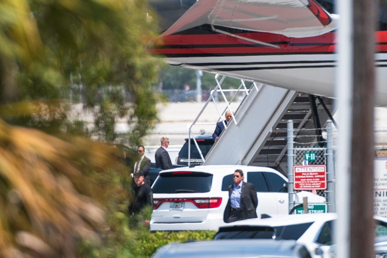 Former President Donald Trump ascends the stairs of his 757 at Palm Beach International Airport on Monday, April 3, 2023, in West Palm Beach, Fla. Trump was departing for New York, where he faces arraignment on Tuesday.