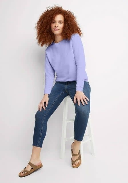 Model wearing purple crewneck sweatshirt