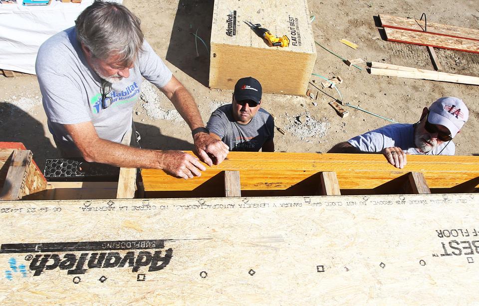 Chuck Abbott, (left) and Curt Samson (right) work to build three Habitat for Humanity homes at Wilmoth Street Wednesday, Sept. 13, 2023, in Ames.