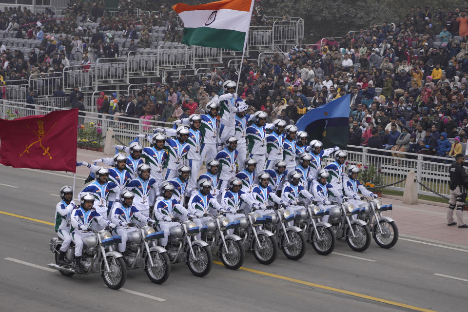An Indian army daredevil team displays their skill on motorcycles as they drive through the ceremonial Kartavya Path boulevard during India's Republic Day celebrations in New Delhi, India, Thursday, Jan. 26, 2023. Tens of thousands of people shed COVID-19 masks but faced morning winter chill and mist at a ceremonial parade in the Indian capital on Thursday showcasing India's defence capability and cultural and social heritage on a long revamped marching ceremonial boulevard from the British colonial rule.(AP Photo/Manish Swarup)