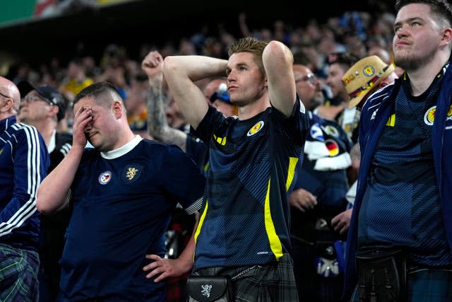 Scotland fans show their dejection after their side's 5-1 defeat in Munich