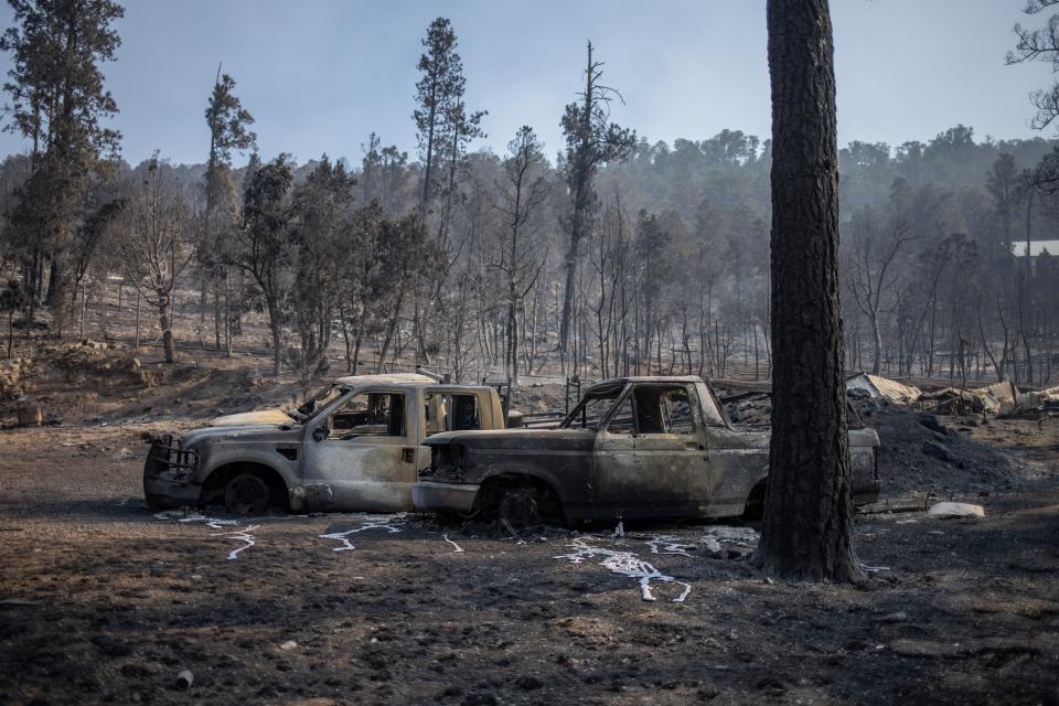 Vehicles sit outside a destroyed residence in the aftermath of the South Fork fire in Alto, New Mexico, U.S., June 19, 2024. REUTERS/Adrees Latif