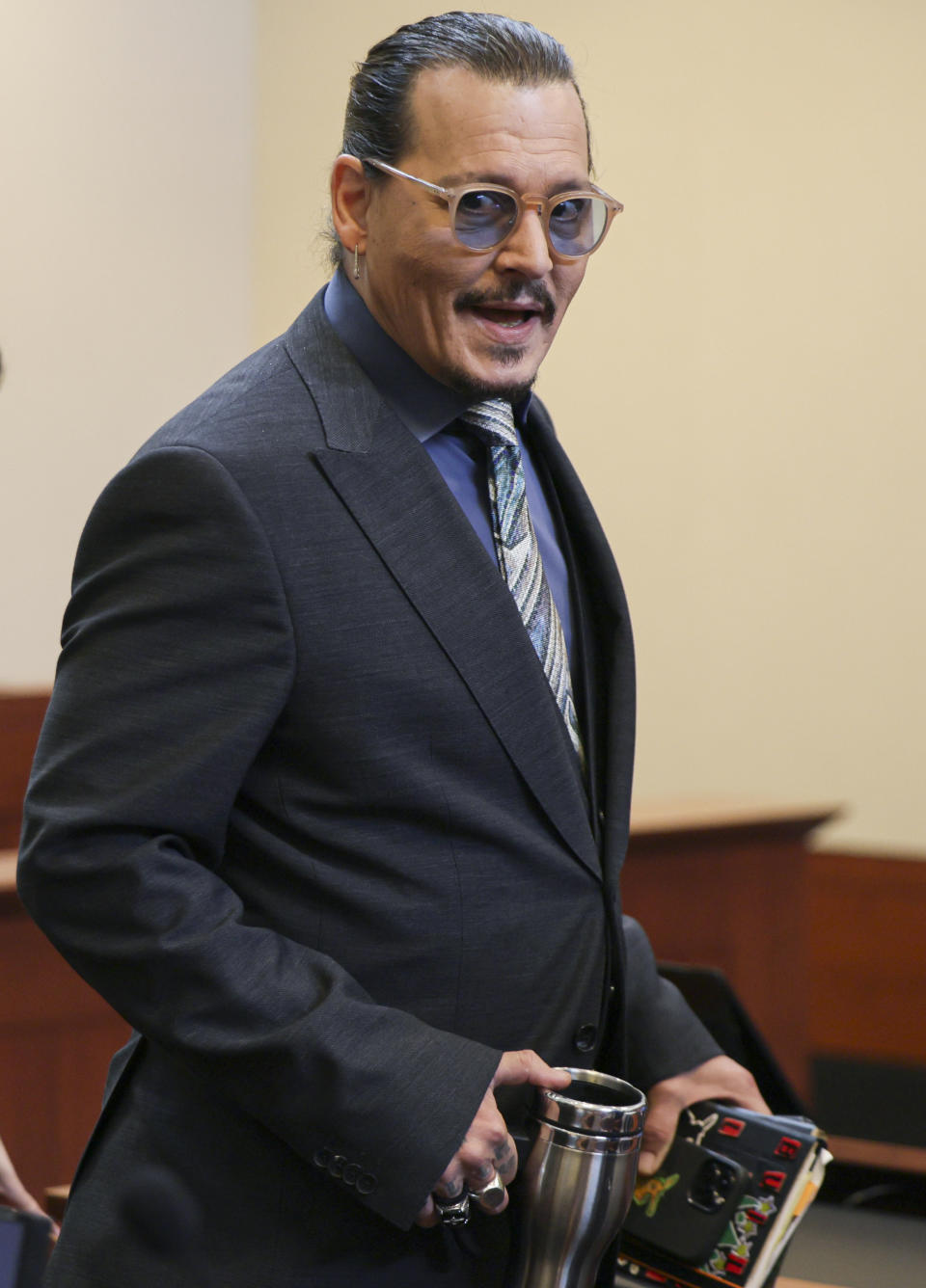 Actor Johnny Depp arrives at the Fairfax County Circuit Courthouse in Fairfax, Va., Wednesday, May 25, 2022. Depp sued his ex-wife Amber Heard for libel in Fairfax County Circuit Court after she wrote an op-ed piece in The Washington Post in 2018 referring to herself as a "public figure representing domestic abuse." (Evelyn Hockstein/Pool photo via AP)