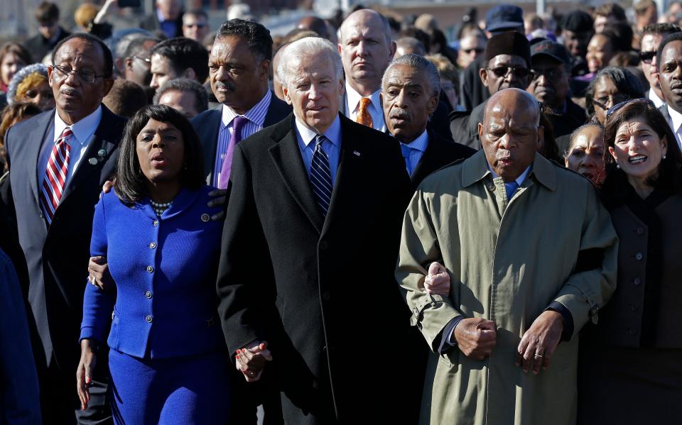 Vice President Joe Biden, center, leads a group across the Edmund Pettus Bridge in Selma, Alabama., March 3, 2013.