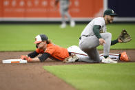 Baltimore Orioles' Gunnar Henderson, left, steals second base against Oakland Athletics second baseman Max Schuemann, right, during the fourth inning of a baseball game, Saturday, April 27, 2024, in Baltimore. (AP Photo/Nick Wass)