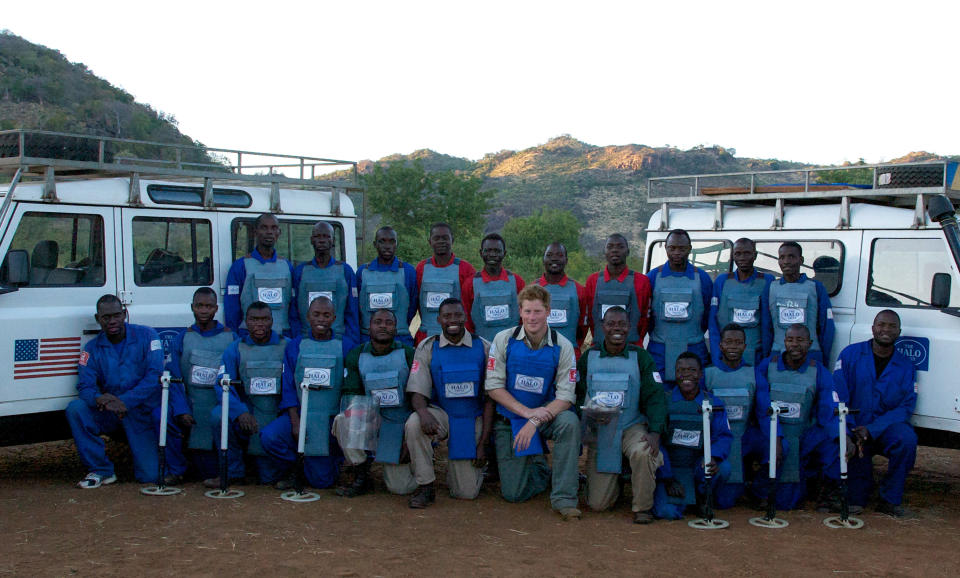 Prince Harry is seen with deminers from The HALO Trust, a British charity dedicated to removal of landmines, on June 21, 2010 in Cahora Bassa, Mozambique [Photo: Getty]