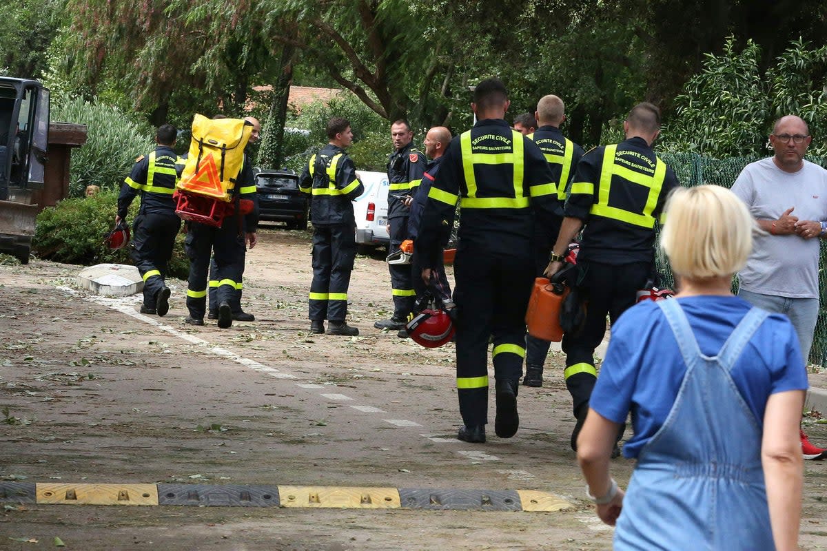 French Securite Civile rescuers enter the Sagone camping in Coggia, where a tree felt on a tent killing two people (AFP via Getty Images)