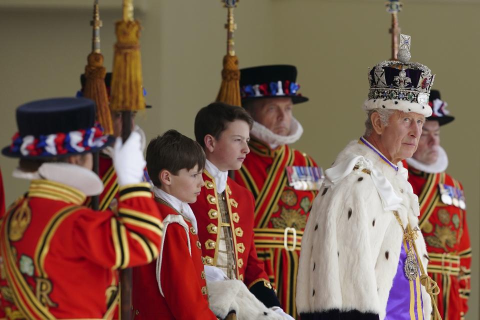 Britain’s King Charles III arrives to receive a royal salute from members of the military in the gardens of Buckingham Palace, following his coronation, in London.