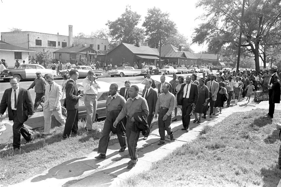 FILE - The Rev. Ralph Abernathy, foreground left, and the Rev. Martin Luther King Jr., foreground right, lead a column of demonstrators as they attempt to march on Birmingham, Ala., City Hall, April 12, 1963. Arrested for leading a march against racial segregation in 1963, King spent days in solitary confinement writing his "Letter From Birmingham Jail," which was smuggled out and stirred the world by explaining why Black people couldn't keep waiting for fair treatment. (AP Photo/Horace Cort, File)