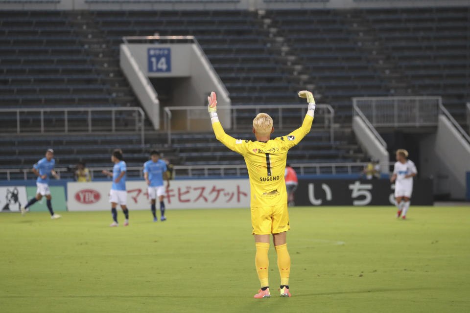 FILE - In this July 4, 2020, file photo, Consadole Sapporo GK Sugino Takanori reacts during their J-League soccer match against Yokohama FC without spectators at Nippatsu Stadium in Yokohama, near Tokyo. Japan’s professional baseball and soccer leagues will begin allowing fans this week, the head of both leagues said on Monday, July 6, 2020. (AP Photo/Koji Sasahara, File)