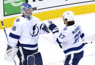 Tampa Bay Lightning goaltender Andrei Vasilevskiy (88) is congratulated by defenseman Ryan McDonagh (27) after the Lightning defeated the Columbus Blue Jackets in Game 4 of an NHL hockey first-round playoff series in Toronto on Monday, Aug. 17, 2020. (Frank Gunn/The Canadian Press via AP)