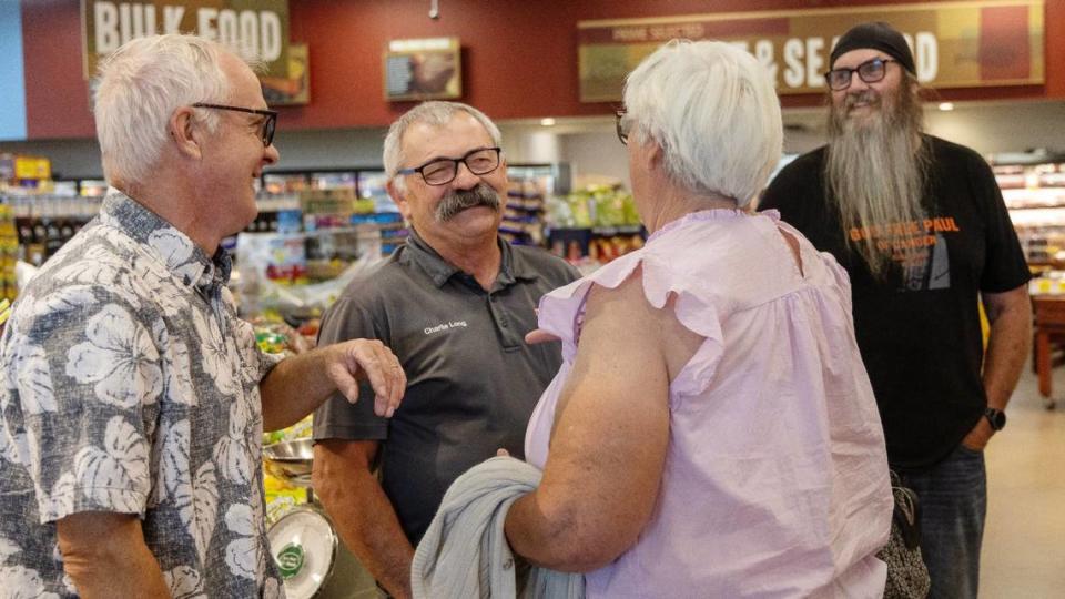 Charlie Long, manager of the Ridley’s Family Market in Kuna, is greeted by customers on his last day of work, Wednesday, July 3, 2024. Long is retiring after decades working in the grocery business.