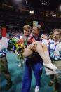 Coach Bela Karolyi carries an injured Kerri Strug of the United States after the 1996 Olympic Games on July 23, 1996 at the Georgia Dome in Atlanta, Georgia. (Photo by Doug Pensinger/Getty Images)