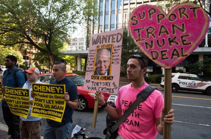 Anti-war protesters hold signs outside the American Enterprise Institute in Washington, DC, where US Vice President Dick Cheney spoke against the Iranian nuclear deal on September 8, 2015 (AFP Photo/Nicholas Kamm)