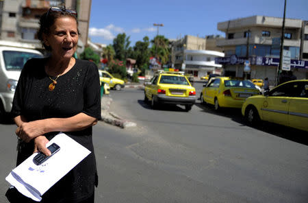 REFILE - CORRECTING TYPO IN DISTRICT'S NAME - Karima Shaaban, 57, is seen along a street at district of Zahraa in Homs city, Syria July 29, 2017. Picture taken July 29, 2017. REUTERS/Omar Sanadiki