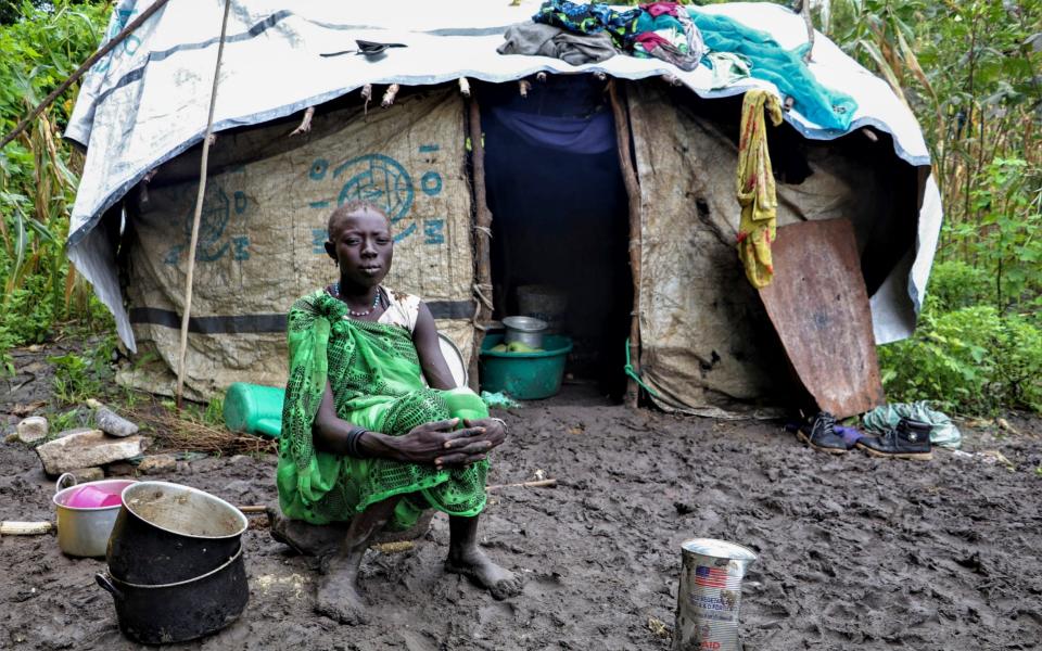 A young Sudanese woman sits in front of her shelter after heavy rainfall and flooding destroyed her crops. Flooding has affected well over a million people across East Africa, another calamity threatening food security on top of a historic locust outbreak and the coronavirus pandemic.  -  Tetiana Gaviuk