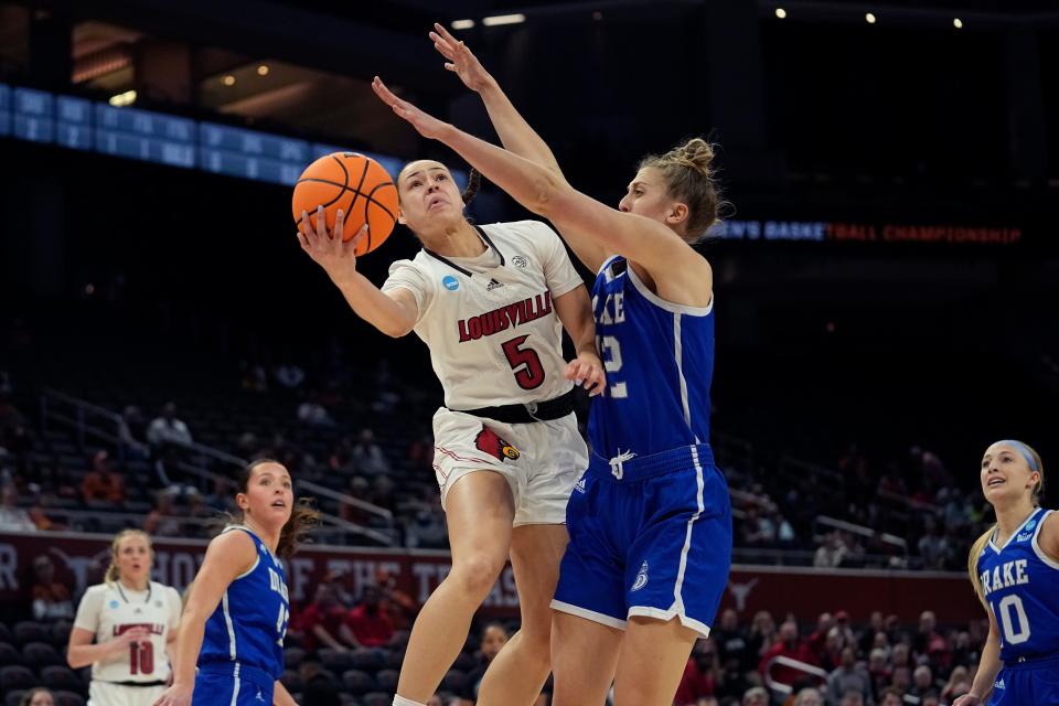 Louisville guard Mykasa Robinson (5) drives to the basket against Drake forward Maggie Bair (42) during the first half of a first-round college basketball game in the NCAA Tournament in Austin, Texas, Saturday, March 18, 2023. (AP Photo/Eric Gay)