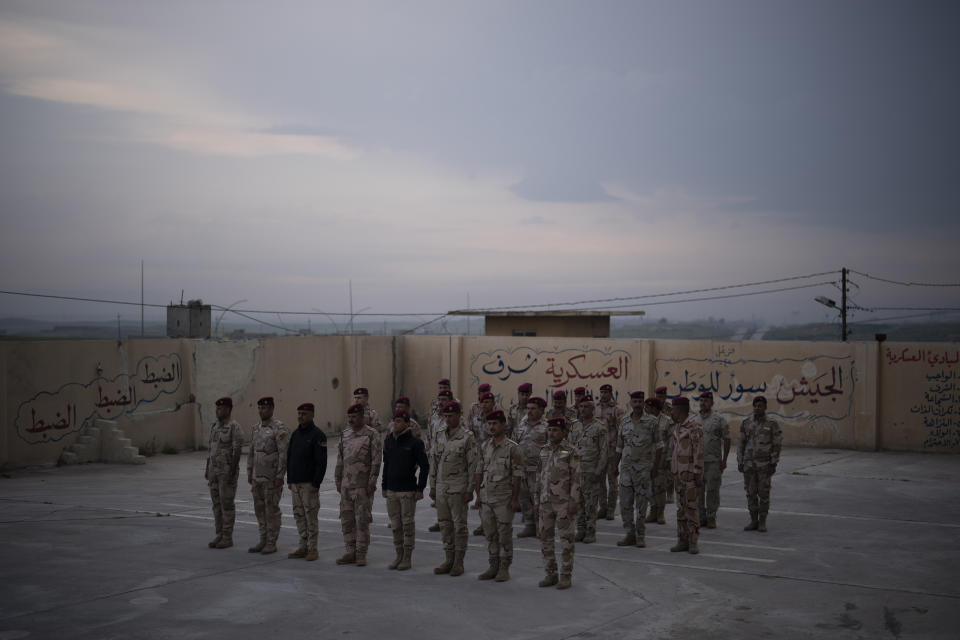 In this April 10, 2019 photo, Iraqi army 20th division soldiers stand in formation at a military base in Badoush, Iraq. (AP Photo/Felipe Dana)