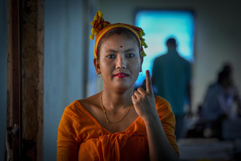 A Deori tribal woman shows the indelible ink mark on her finger after casting her vote during the first round of polling of India's national election in Jorhat, India, Friday, April 19, 2024. Nearly 970 million voters will elect 543 members for the lower house of Parliament for five years, during staggered elections that will run until June 1. (AP Photo/Anupam Nath)