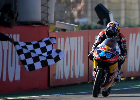 FILE PHOTO: KTM Moto3 rider Miguel Oliveira of Portugal crosses the finish line to win the race during the Valencia Motorcycle Grand Prix at the Ricardo Tormo racetrack in Cheste, near Valencia, November 8, 2015. REUTERS/Heino Kalis/File Photo