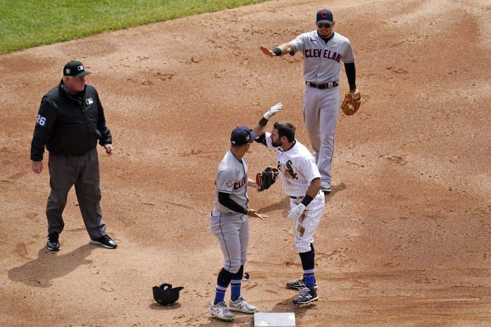 Chicago White Sox's Adam Eaton, bottom right, and Cleveland Indians shortstop Andres Gimenez, second from left, get into an argument at second base as Indians second baseman Cesar Hernandez, top right, watches during the first inning of a baseball game in Chicago, Thursday, April 15, 2021. (AP Photo/Nam Y. Huh)