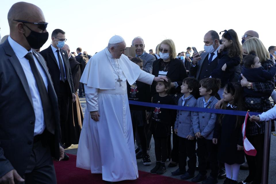 Pope Francis arrives at the airport in Larnaca, Cyprus, Thursday, Dec. 2, 2021. Pope Francis' trip to Cyprus and Greece is drawing new attention to the plight of migrants on Europe's borders and the disconnect between Francis' Gospel-driven call for countries to welcome and integrate them and front-line governments that are increasingly unwilling or unable to let them in. (AP Photo/Alessandra Tarantino)