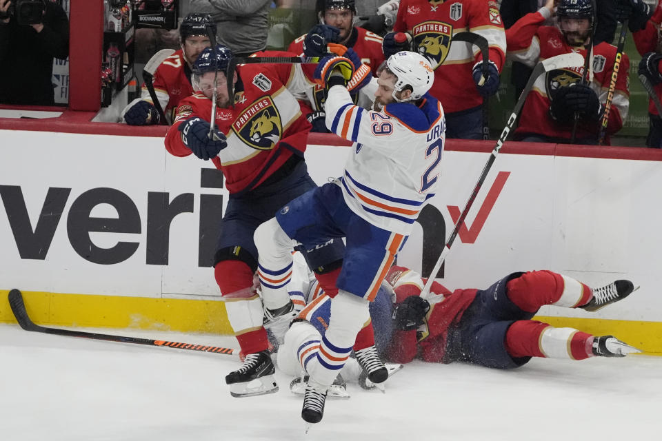 Florida Panthers right wing Vladimir Tarasenko (10) and Edmonton Oilers center Leon Draisaitl (29) collide during the second period of Game 5 of the NHL hockey Stanley Cup Finals, Tuesday, June 18, 2024, in Sunrise, Fla. (AP Photo/Rebecca Blackwell)