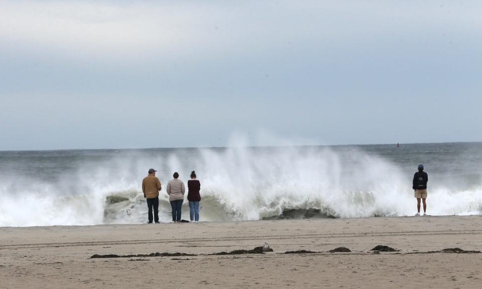 People gather at Hampton Beach about two hours ahead of high tide Saturday, Sept. 16, 2023.