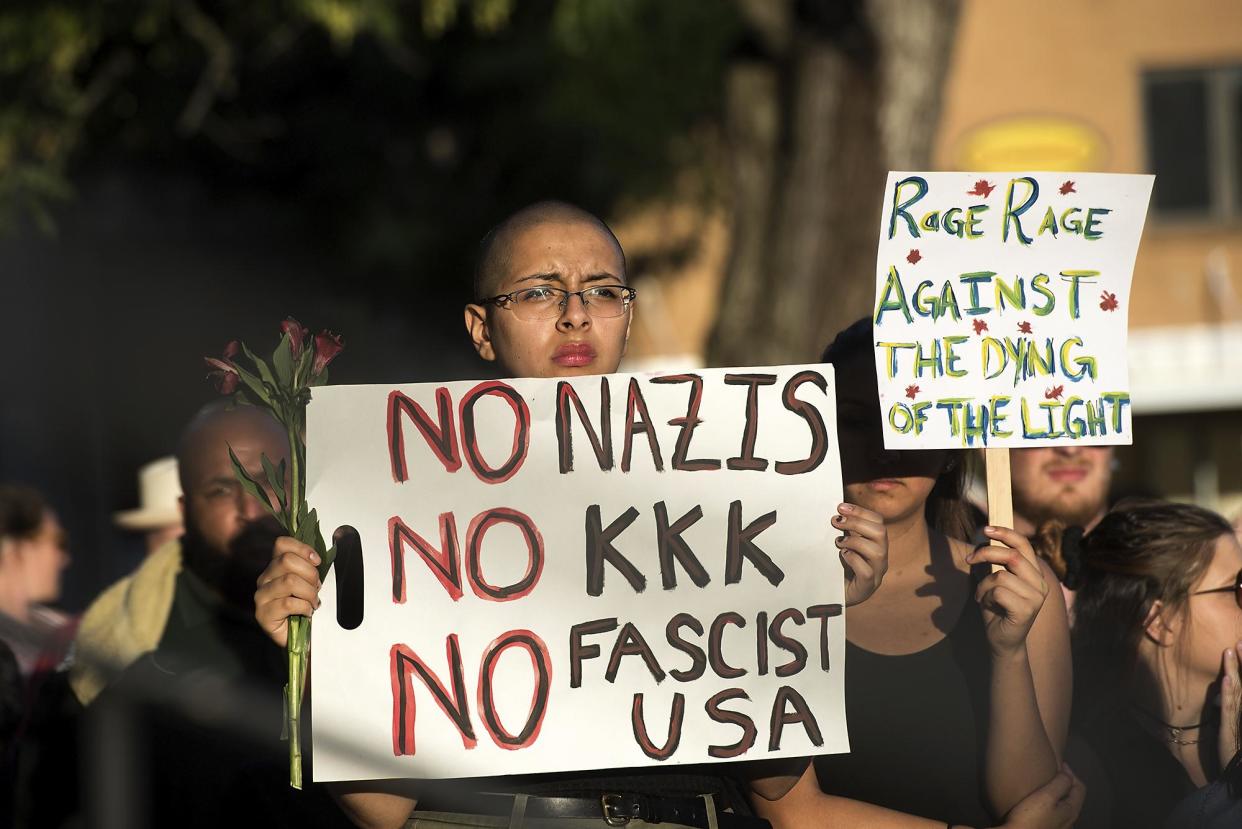 Demo: A woman holds up a sign at a protest after violence erupted at a white supremacist rally in Charlottesville: AP