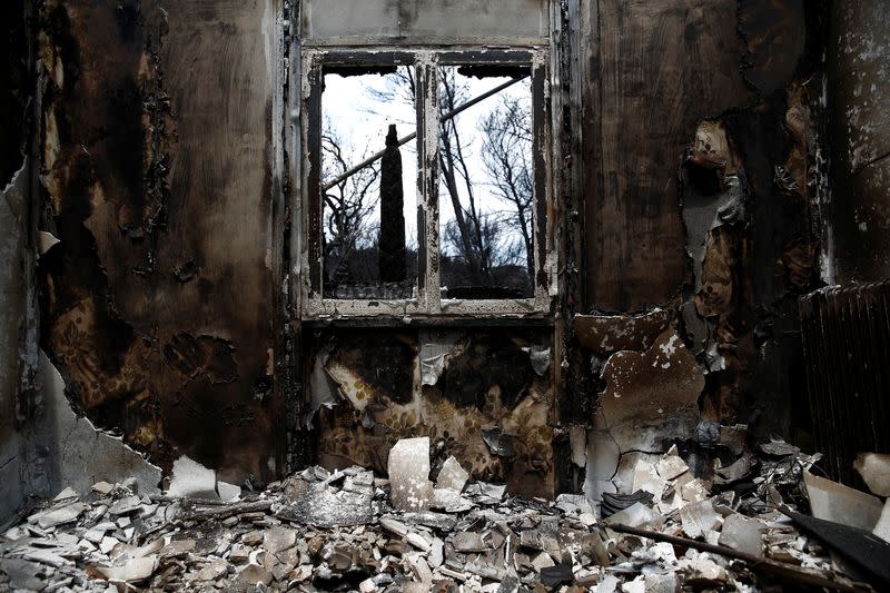 The interior of a burnt house is seen following a wildfire in the village of Mati, near Athens