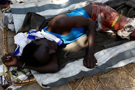 A wounded man lies on a stretcher following an armed confrontation between two communities, in Thonyor, Leer state, South Sudan, February 25, 2017. REUTERS/Siegfried Modola