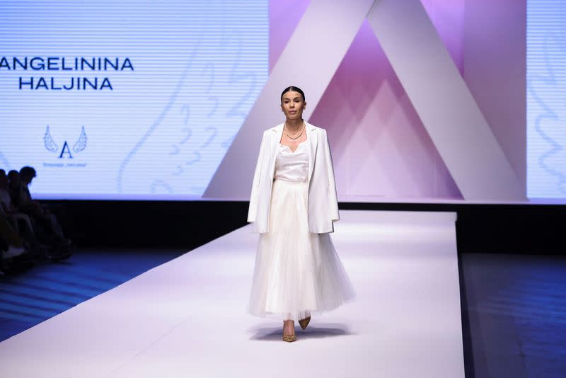 Dresses based on drawings of a victim of Serbia's school shooting are presented during a Fashion Week in Belgrade