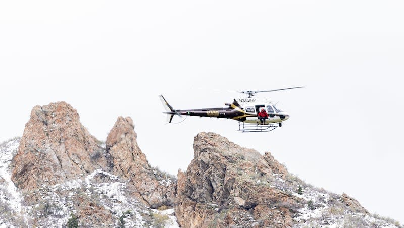 A Utah Department of Public Safety helicopter flies from Hidden Valley Park in Sandy after emergency crews responded to a report of an avalanche and three missing skiers in the Little Cottonwood Canyon area on Thursday, May 9, 2024.
