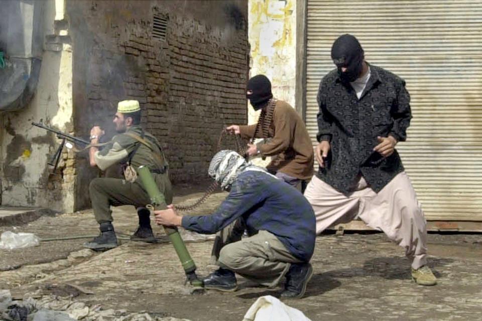 FILE - Insurgents, using small arms and mortars, launch an attack on U.S. forces in Fallujah, Iraq, Nov. 8, 2004. (AP Photo/Bilal Hussein, File)