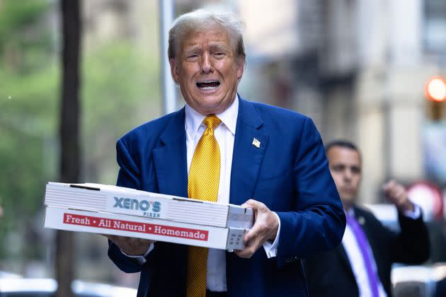 NEW YORK, NEW YORK - MAY 02: Republican presidential candidate former U.S. President Donald Trump carries boxes of pizza for the FDNY Engine 2, Battalion 8 firehouse on May 02, 2024 in New York City. Trump delivered pizza to a firehouse after a court appearance in his hush money trial, which started with a hearing where prosecutors argued that Judge Juan Merchan should find Trump in criminal contempt again for violating a gag order. Earlier this week, Trump was found in contempt for nine violations of his April 1 order prohibiting criticism of witnesses and jurors. (Photo by Michael M. Santiago/Getty Images)