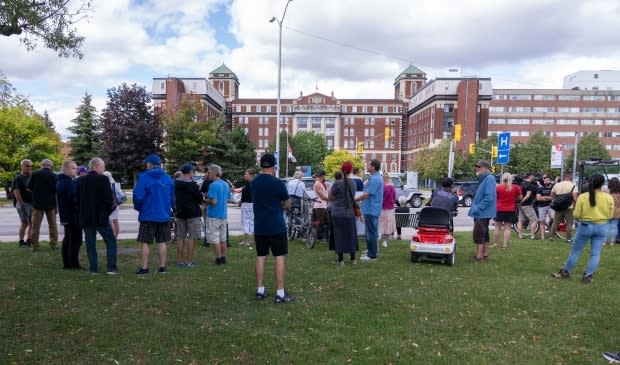 Protesters gather across from the Ottawa Hospital's Civic campus on Carling Avenue to denounce public health measures during the COVID-19 pandemic on Sept. 13, 2021. (Francis Ferland/CBC - image credit)