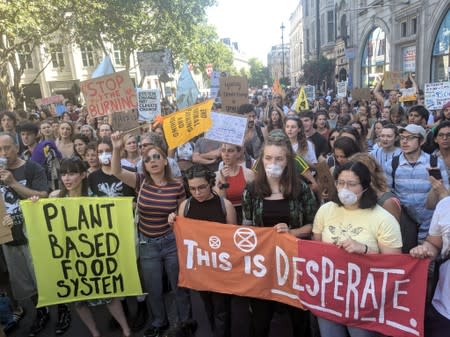 People demonstrate during an Extinction Rebellion protest outside the Brazilian embassy in London