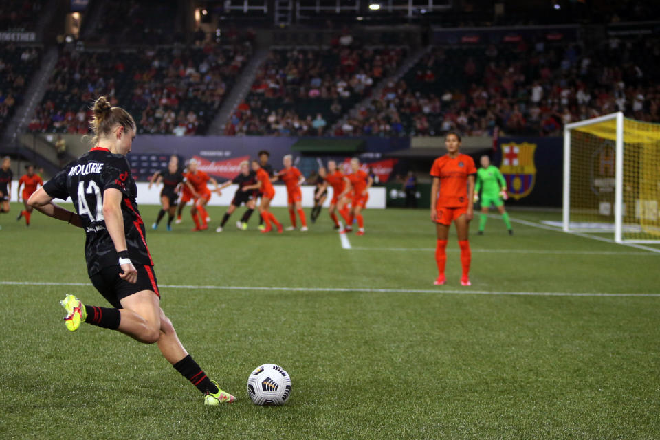 Portland Thorns midfielder Olivia Moultrie winds up for a free kick as the Thorns and Houston Dash meet in a semifinals matchup of the Women's International Champions Cup at Providence Park in Portland, Ore., Wednesday, Aug. 18, 2021. It's been a little more than a year since Olivia Moultrie signed with the Portland Thorns after suing to join the National Women's Soccer League at just 15 years old. For Moultrie, the lasting lesson of her legal odyssey is that women should have the same opportunities to reach the top tier of U.S. pro soccer as men. Even if they're still teenagers. (Sean Meagher/The Oregonian via AP)