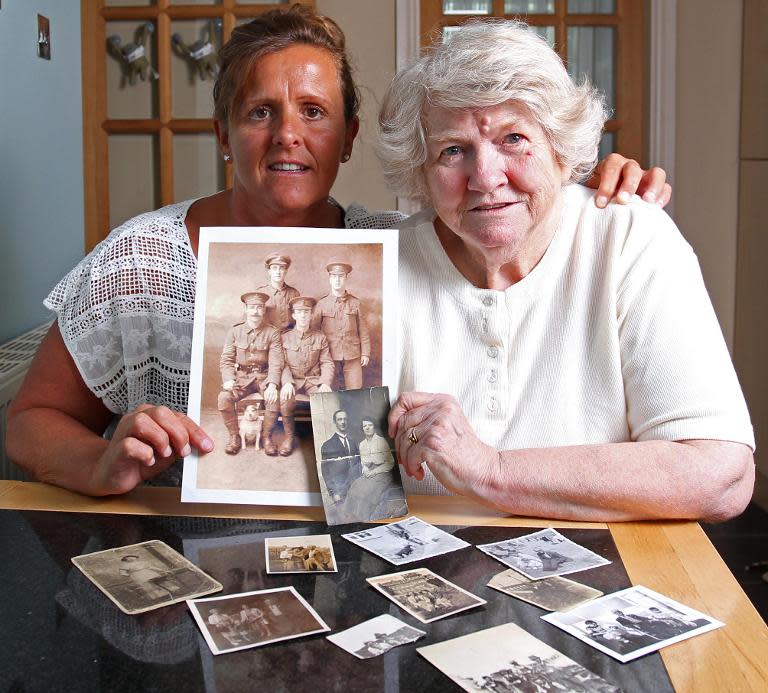 Amanda Nelson (L) and her mother Diane, granddaughter and daughter of former WWI British soldier Wilfred Smith, pose for pictures in Barnard Castle near County Durham, on July 11, 2014, with pictures of him and his brothers