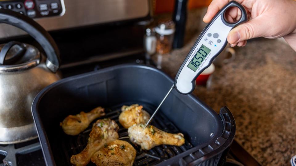 Using a digital thermometer on chicken