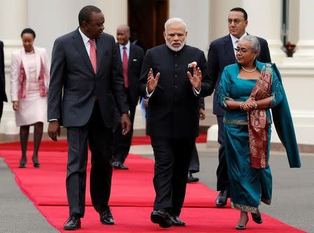 Indian Prime Minister Narendra Modi (C) walks with Kenyan President Uhuru Kenyatta and First Lady Margaret during the official welcoming ceremony at the State House in Nairobi, Kenya, July 11, 2016. REUTERS/Thomas Mukoya