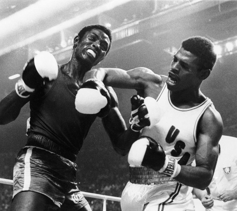 FILE- In this July 31, 1976, file photo, the United States' Leon Spinks lets a right fly at the face of Cuba's Sixto Soria during light heavyweight boxing action at the Olympics in Montreal. Former heavyweight champion Leon Spinks Jr. died Friday night, Feb. 5, 2021, after battling prostate and other cancers. He was 67. (AP Photo/File)