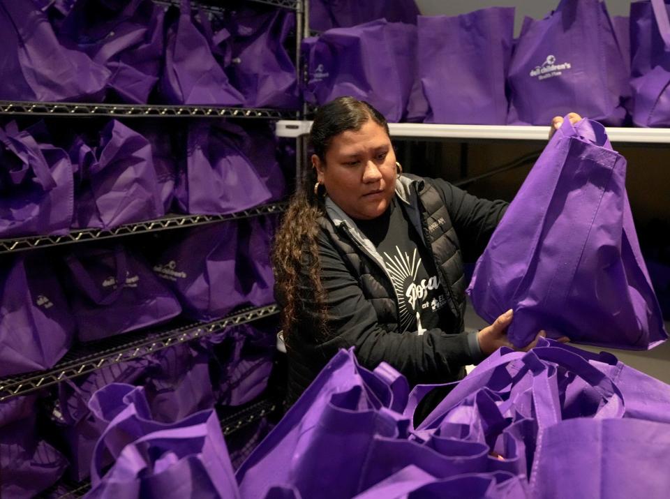 Volunteer Marisol Reyes works on meal kits Friday for Posadas at El Buen.