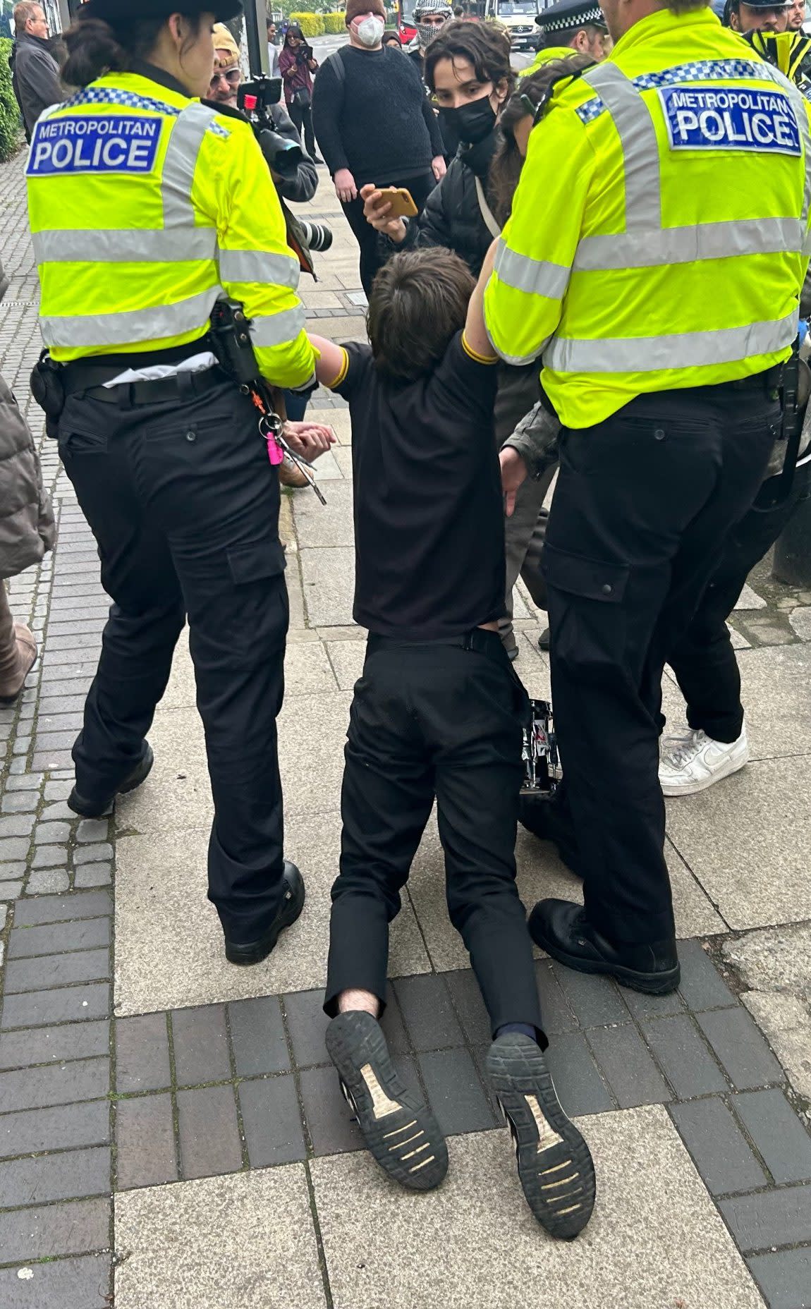 A protester is dragged away by police