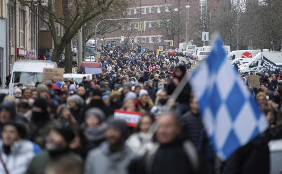 Demonstrators march through Nuremberg, Germany, against the Corona rules on Sunday, Dec. 19, 2021. Under the motto "Enough. If not now, when? Nuremberg against compulsory vaccination." the group "Pupils stand up" had called for a demonstration against the current Corona measures. (dpa via AP)